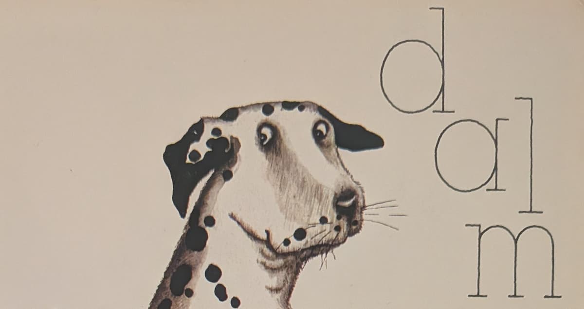 The head of a dalmation dog. It is looking sideways at us with a worried expression.